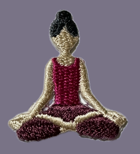 Embroidered patch of a person in a yoga pose