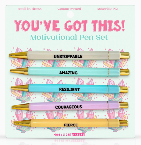 Motivational pen set with pens labeled 'Unstoppable', 'Amazing', 'Resilient', 'Courageous', and 'Fierce' on a decorative card.