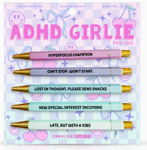 Pen set with colorful pens and humorous text on a pastel background, branded as 'ADHD GIRLIE'.