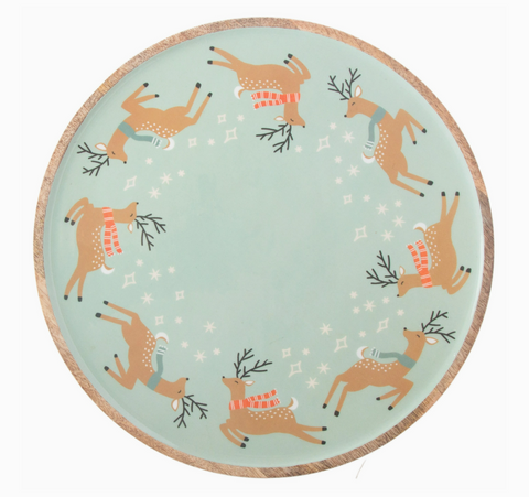 Round wood plate with reindeer design on a light blue background