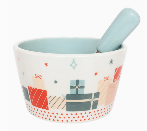 Ceramic bowl with seasonal decorative design of gifts and matching spreader